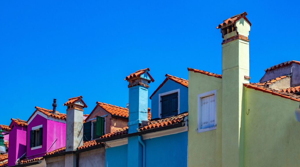 Colorful Spanish titled row houses underneath blue sky